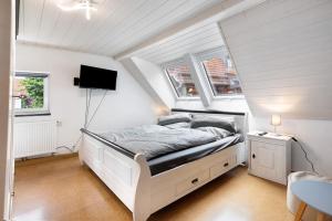 a bedroom with a white bed in a attic at Ferienwohnung im Ländle in Reutlingen