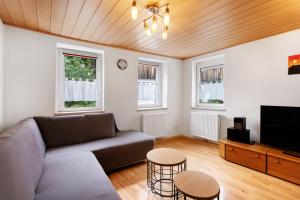 a living room with a couch and a flat screen tv at Ferienwohnung im Ländle in Reutlingen