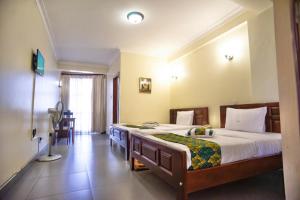 Ένα ή περισσότερα κρεβάτια σε δωμάτιο στο Kenendia Hotel