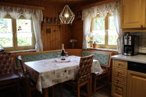 a kitchen with a table with a bottle of wine on it at Haus Anna Königsdorfer in Neureichenau