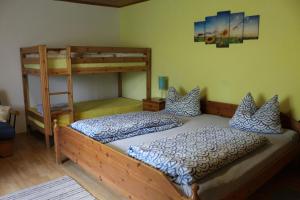 a bedroom with two bunk beds and a ladder at Haus Anna Königsdorfer in Neureichenau