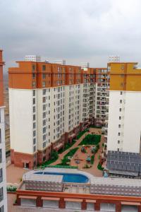 a view of a large apartment complex with a pool at Greyscape Apple Tree Apartment in Nairobi