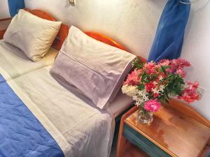 A bed or beds in a room at Hotel Helena