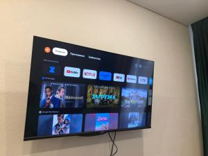 a flat screen tv hanging on a wall at Бухар -Жырау 72 in Karagandy