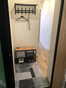 a hallway with a table and a hanger at Бухар -Жырау 72 in Karagandy