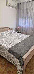 a bedroom with a bed and a window at Casa 33 in Lagos