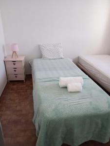 a bedroom with two twin beds and a night stand at Casa 33 in Lagos