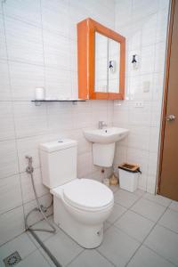 a bathroom with a toilet and a sink at Le Ans Haven fully-furnished homestay in Puerto Princesa City