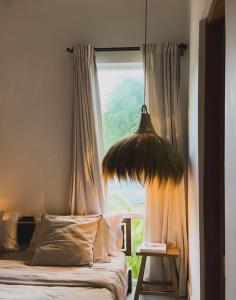 a bed in a room with a large window at CASA ROSA 49’ - Playa Venao Beach in Playa Venao