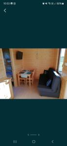 a living room with a couch and a table at Domki Cichy Zakątek in Darłowo