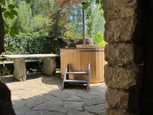 a chair sitting on a patio with a table and bench at Domek w Brzezowej in Brzezowa