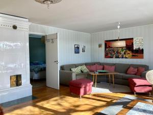 a living room with a couch and a table at Krokens Gård in Fotskäl