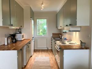 a kitchen with white cabinets and a counter top at Krokens Gård in Fotskäl