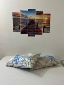 a painting of a pier over the ocean at Casa Maria Bartolomeo in Marsala