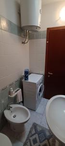 a small bathroom with a sink and a toilet at Casa Angela in Valledoria +8 photos
