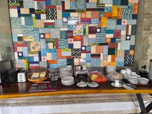 a table with dishes and a mosaic wall at Hotel Sari Bunga in Legian