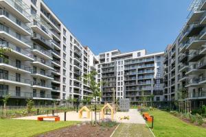an apartment complex with a playground in a park at Verde Kato Apartment Francuska - FREE PARKING - Self check-in in Katowice