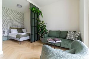 a living room with a green couch and a chair at Verde Kato Apartment Francuska - FREE PARKING - Self check-in in Katowice
