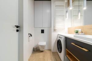 a white bathroom with a toilet and a sink at Verde Kato Apartment Francuska - FREE PARKING - Self check-in in Katowice +16 photos
