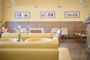a waiting room with couches and a table and chairs at BRISTOL Hotel Opatija in Opatija