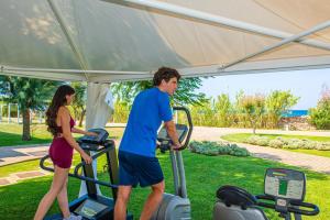 a man and a woman on a treadmill in a park at Pietrablu Resort & Spa - CDSHotels in Polignano a Mare