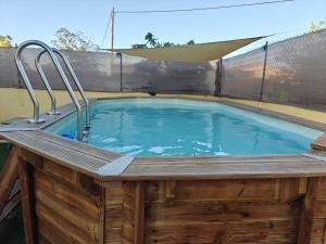 a pool with a hot tub in a backyard at Beautiful House Delta Ebro in Camarles