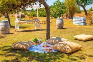 a group of pillows on a blanket under a tree at Pietrablu Resort & Spa - CDSHotels in Polignano a Mare