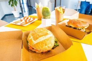 a sandwich in two boxes on a table at Pietrablu Resort & Spa - CDSHotels in Polignano a Mare