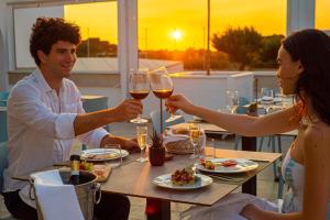 a group of people sitting at a table with wine glasses at Pietrablu Resort & Spa - CDSHotels in Polignano a Mare