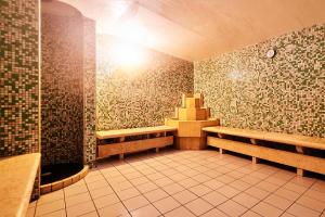 a room with two benches and a tiled floor at Pietrablu Resort & Spa - CDSHotels in Polignano a Mare