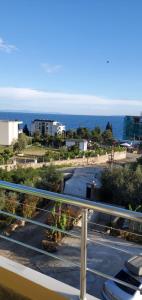 a view of a parking lot with the ocean in the background at Hotel Afrodite in Dhërmi