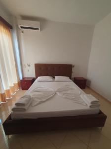 a large bed in a room with at Hotel Afrodite in Dhërmi