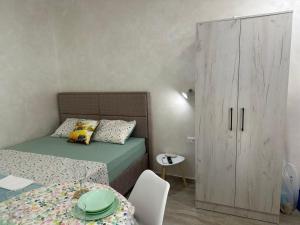 a small bedroom with a bed and a cabinet at Dalupada Apartments in Zgrada