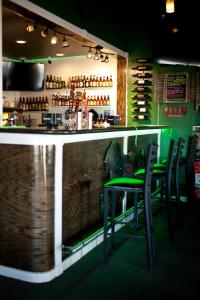 a bar in a restaurant with chairs and a counter at Emerald Inn & Lounge in Blythe