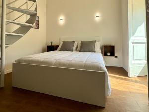a bedroom with a large bed with a staircase at Montesanto Charm Centro Storico in Naples +18 photos