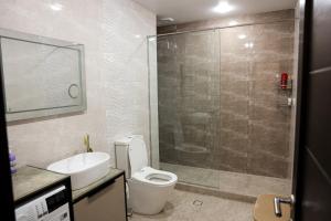 a bathroom with a toilet and a sink and a shower at Silent Apartment 1 in Yerevan +3 photos