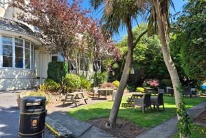 a trash can in the yard of a house at Trecarn Hotel in Torquay