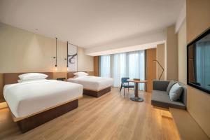 Postel nebo postele na pokoji v ubytování Fairfield by Marriott Shenzhen Dameisha