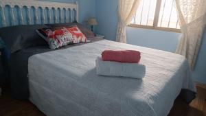 a bedroom with a bed with two towels on it at Villas Moraig in Benitachell