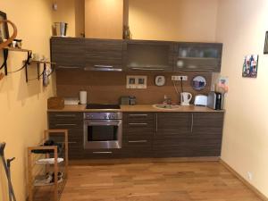 a kitchen with a stove and a sink at Võsu männisalu apartament in Võsu