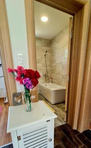 a bathroom with a vase of flowers on a table at Kosta's White House in Plav