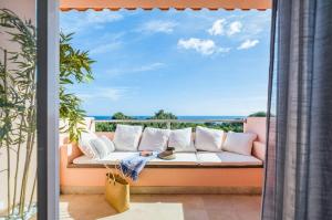 a couch on a balcony with a view of the ocean at Luxury Sea View in Cascais