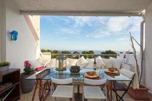 a living room with a glass table and chairs at Luxury Sea View in Cascais