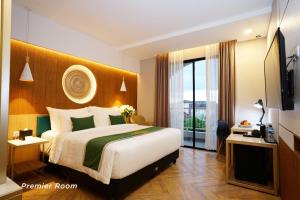 a hotel room with a large bed and a window at Patra Malioboro Hotel in Yogyakarta
