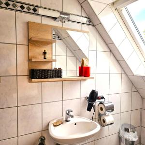 a bathroom with a sink and a mirror at Haus Scheuten Hotel in Duisburg +56 photos