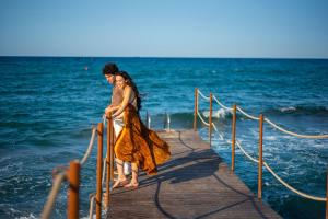 a couple standing on a dock in the ocean at Pietrablu Resort & Spa - CDSHotels in Polignano a Mare