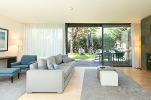 a living room with a couch and a table at VILLA FARHAT in Troia
