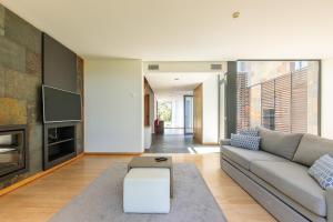 a living room with a couch and a fireplace at VILLA FARHAT in Troia +15 photos