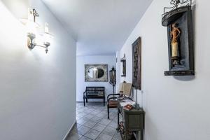 a hallway with white walls and a table and a chair at Prado del abuelo in Cabezuela del Valle