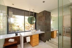 a bathroom with a sink and a glass shower at VILLA FARHAT in Troia